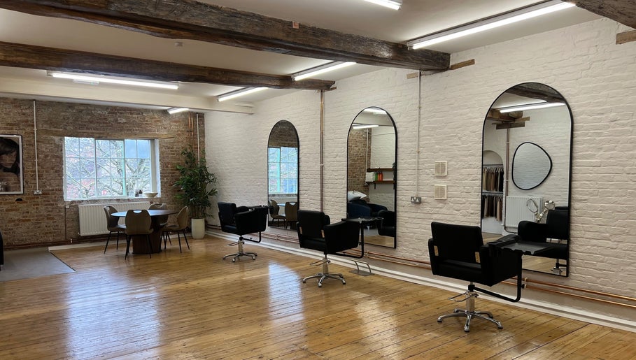 Modern salon interior at Molly May Extensions Hair Salon, Gainsborough, England, GB with stylish chairs and mirrors.