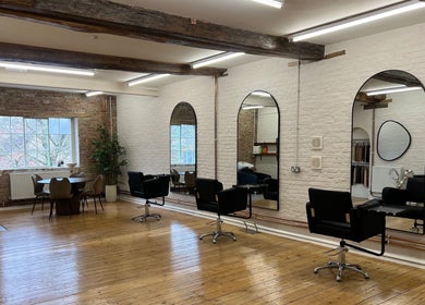 Modern salon interior at Molly May Extensions Hair Salon, Gainsborough, England, GB with stylish chairs and mirrors.