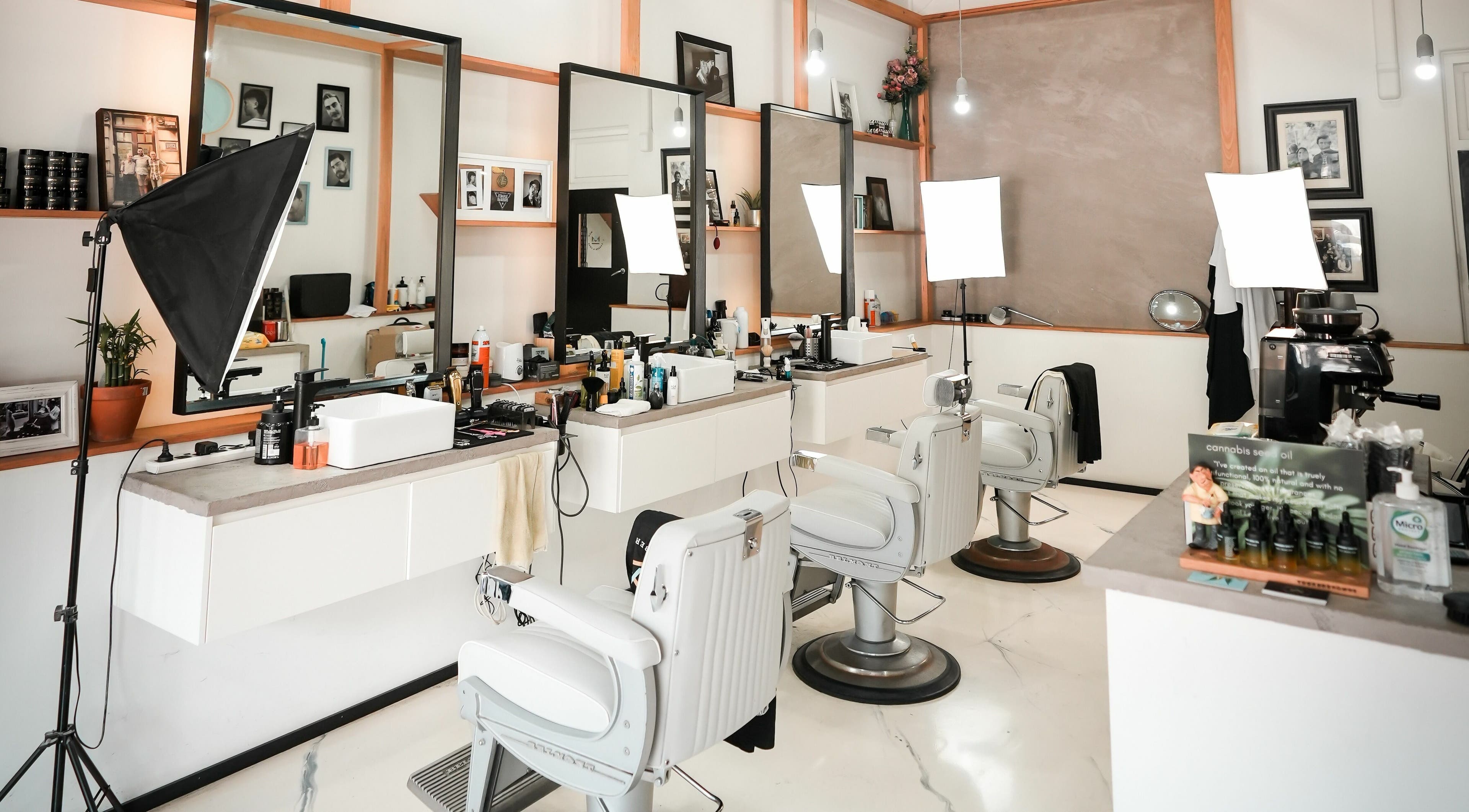 Inside Caulfield North - Another Man Barber and Shop, Melbourne, Victoria, AU. Modern barber chairs and sleek decor.