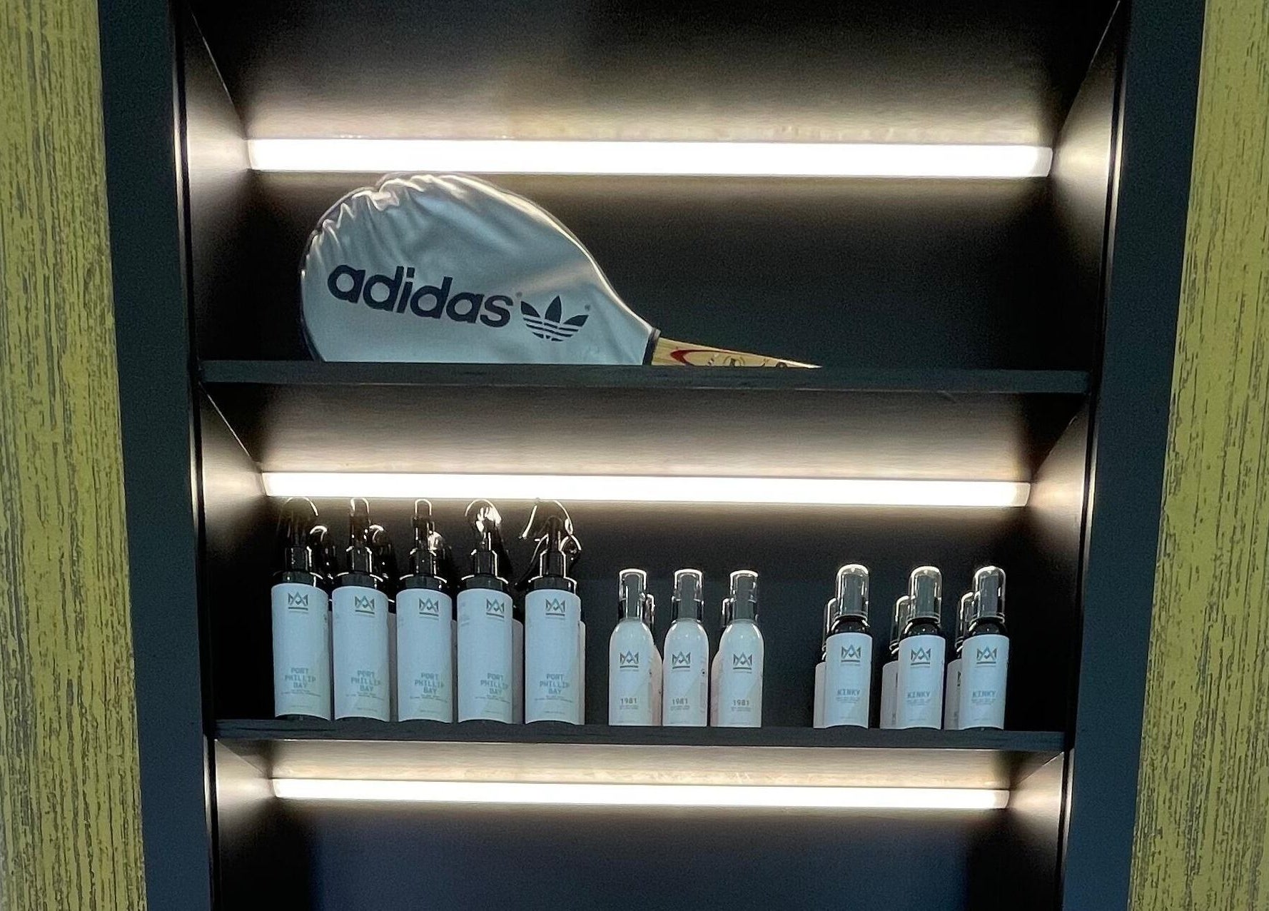 Stylish product shelf at Ripponlea - Another Man Barber & Shop, Melbourne, Victoria, AU with Adidas cap.