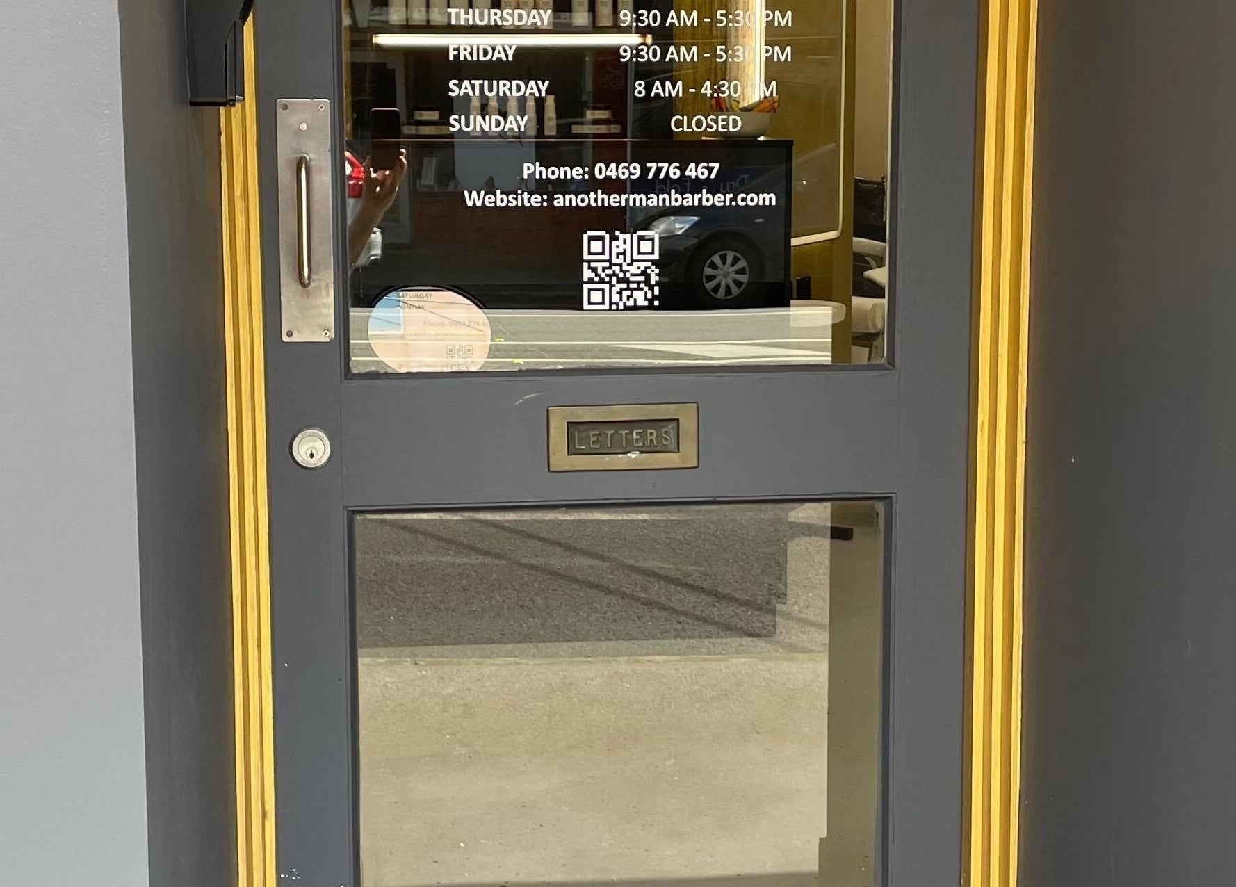 Entrance of Ripponlea - Another Man Barber & Shop in Melbourne, Victoria, AU, featuring glass door and business hours.