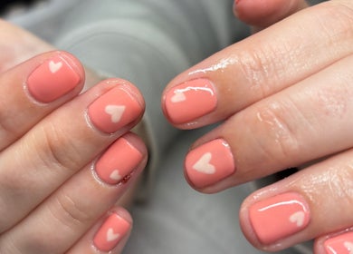 Heart-accented peach nails by The Beauty Room by Victoria, Chelmsford, England, GB.