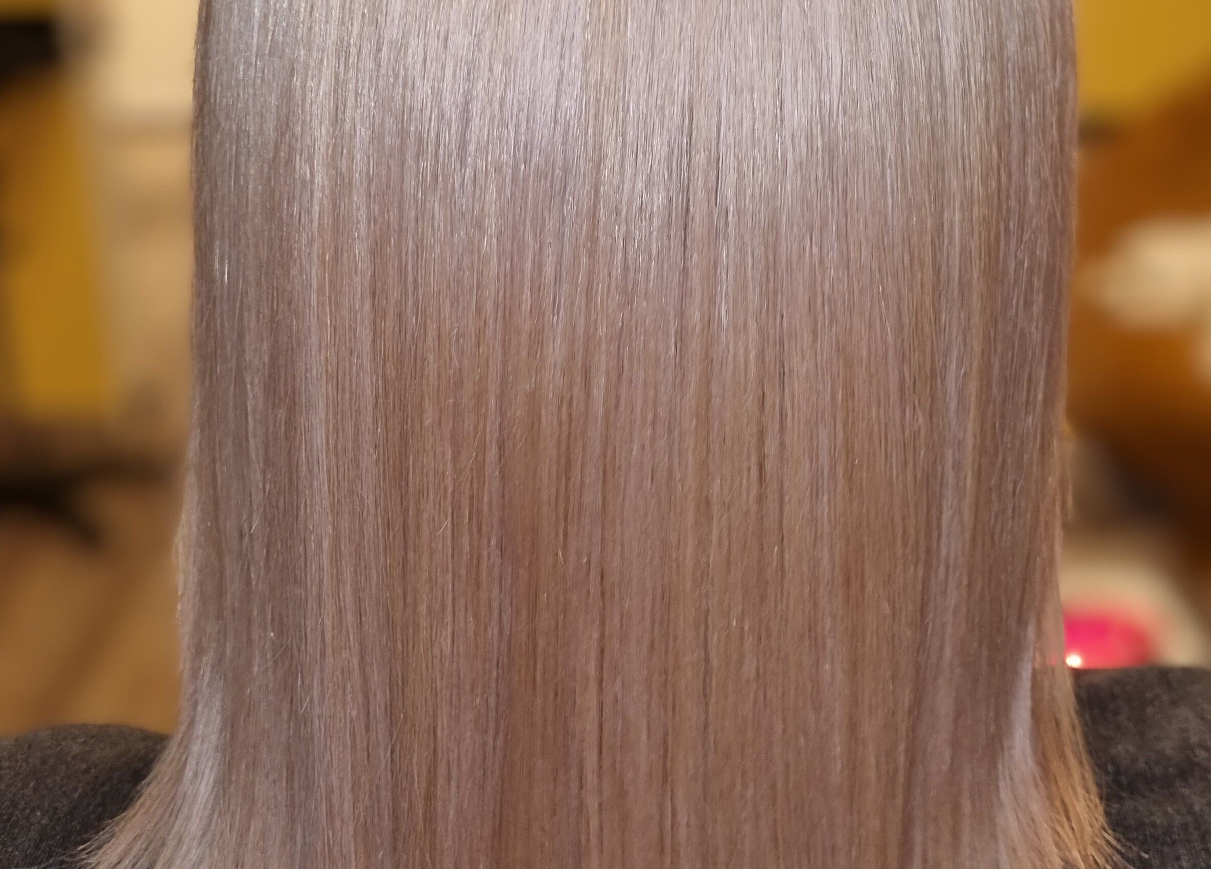 Sleek hair styled at Kay's Tresses, located in Birmingham, England, GB, highlighting expert hairstyling.