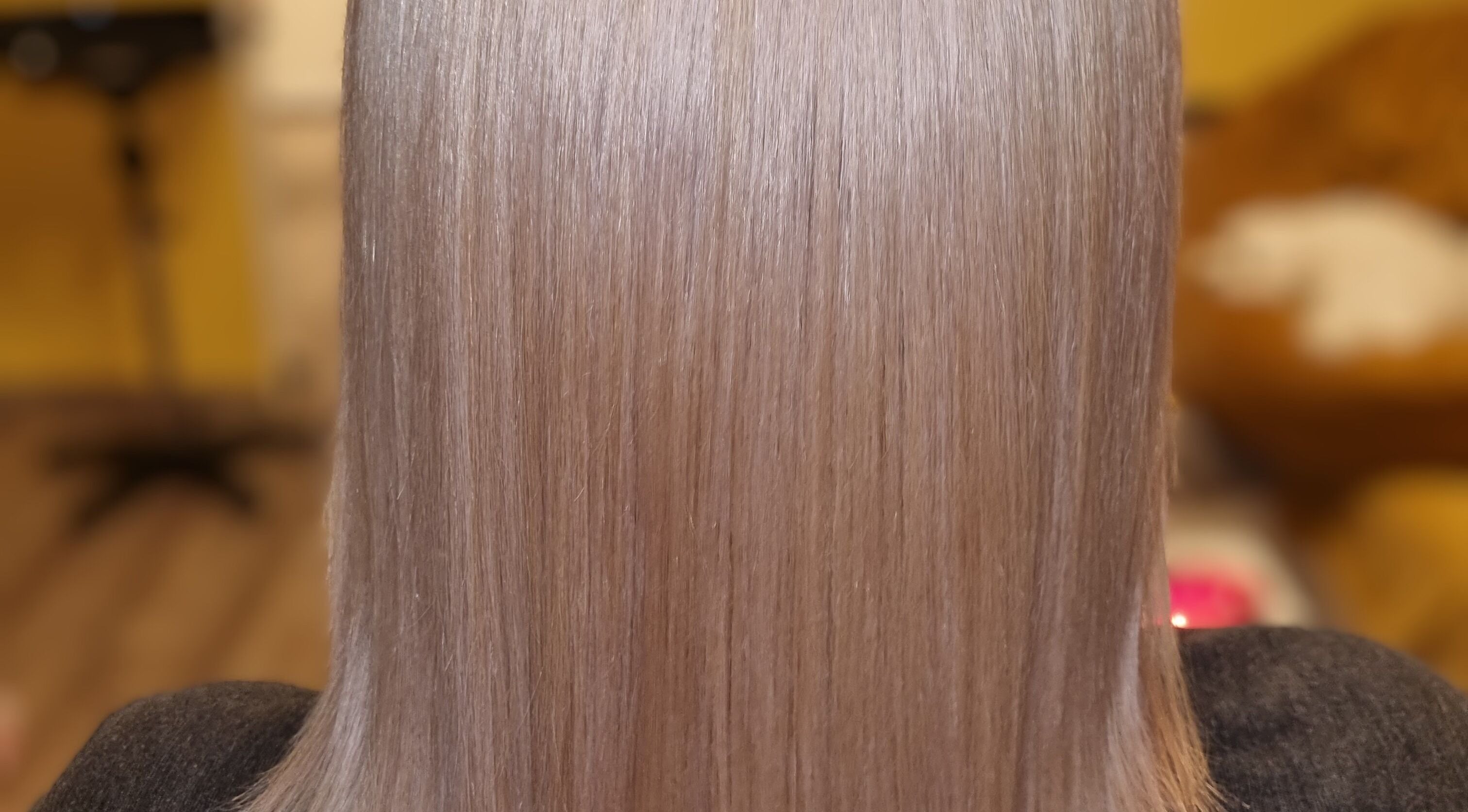 Sleek hair styled at Kay's Tresses, located in Birmingham, England, GB, highlighting expert hairstyling.