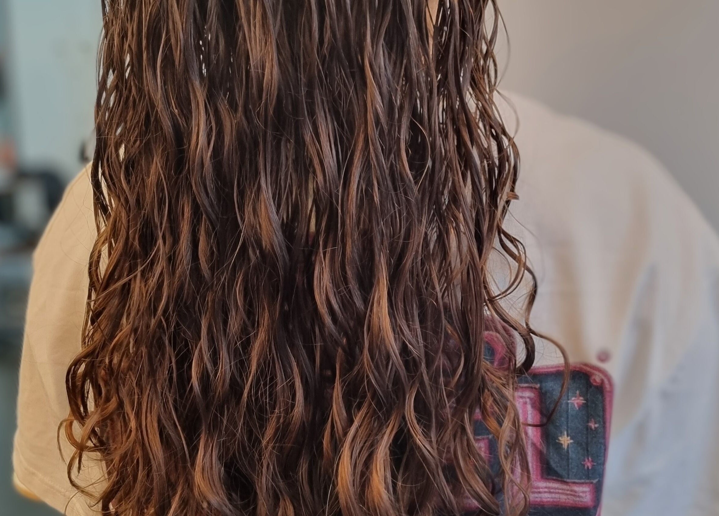 Close-up of flowing curly hair styled at Kay's Tresses, Birmingham, England, GB.