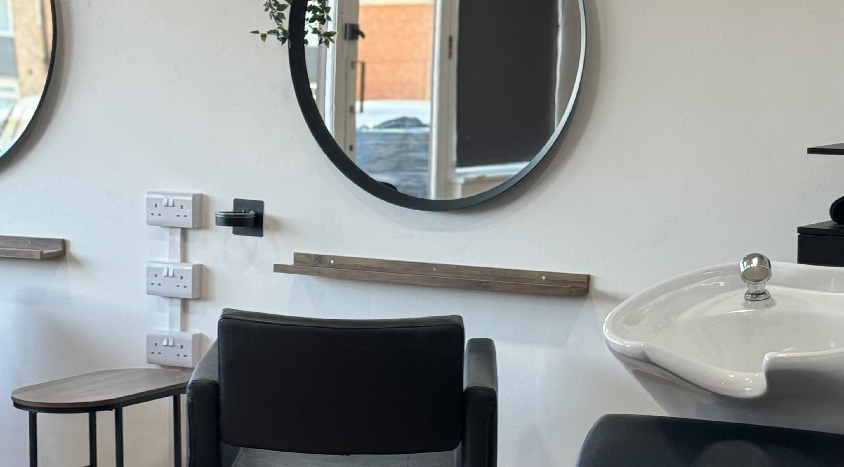 Stylish salon setup at Afterglow at 102, Fareham, England, GB, featuring a round mirror and chic styling chair.