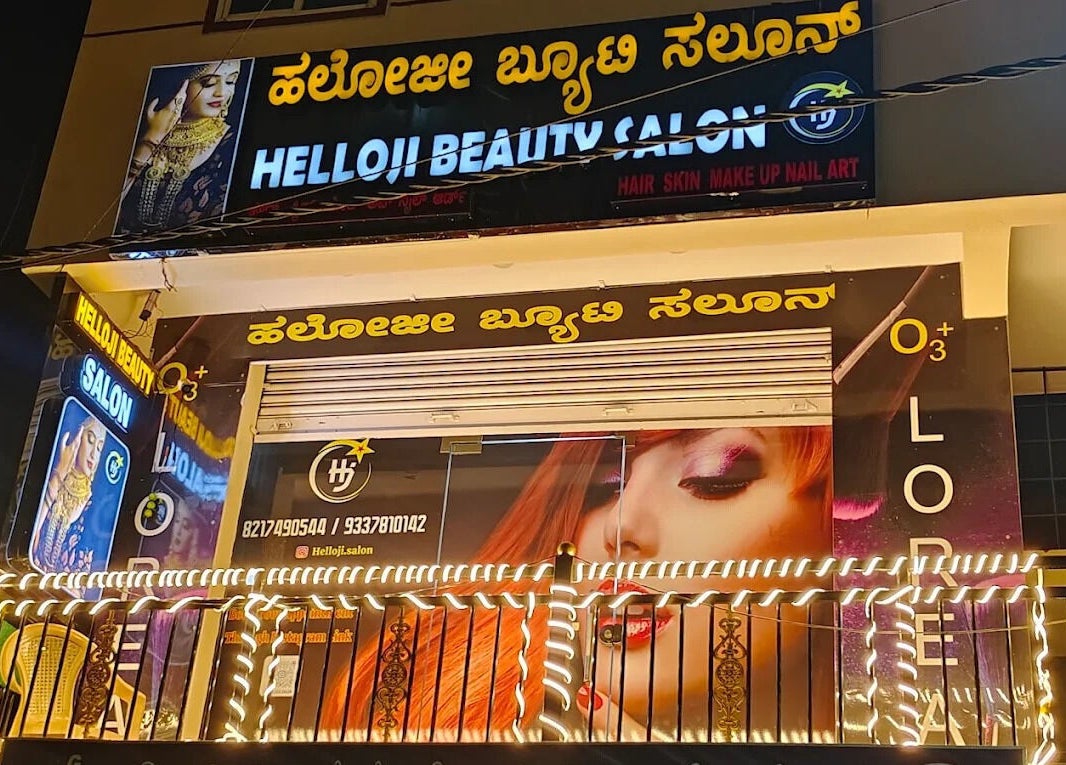Exterior of Helloji Beauty Salon in Bengaluru, Karnataka, IN lit up with vibrant lights and signage.
