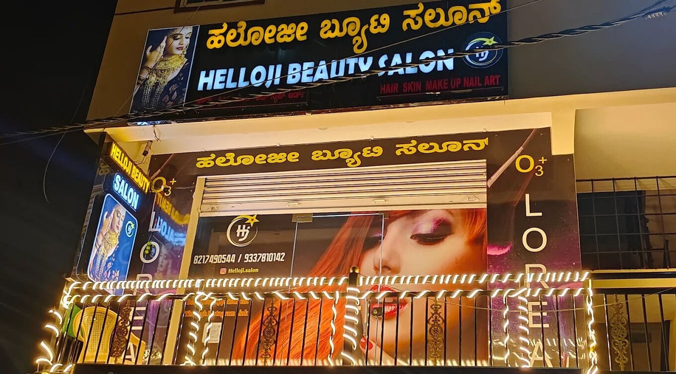Exterior of Helloji Beauty Salon in Bengaluru, Karnataka, IN lit up with vibrant lights and signage.