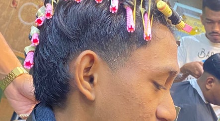 Hair curling session at THE CUTZS, Machang, Kelantan, MY showcasing vibrant styling tools.