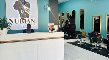 Reception and styling area at Nubian Crown Hyde Park, Sandton, Gauteng, ZA. Modern decor with mirrors and chairs.