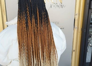 Stylish braids at Nubian Crown Hyde Park, Sandton, Gauteng, ZA, showcasing intricate hair artistry.
