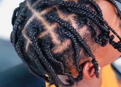 Intricate braided hairstyle at Nubian Crown Hyde Park, Sandton, Gauteng, ZA.