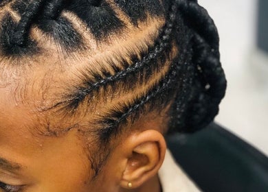 Intricate braided hairstyle at Nubian Crown Hyde Park, Sandton, Gauteng, ZA, showcasing expert styling.