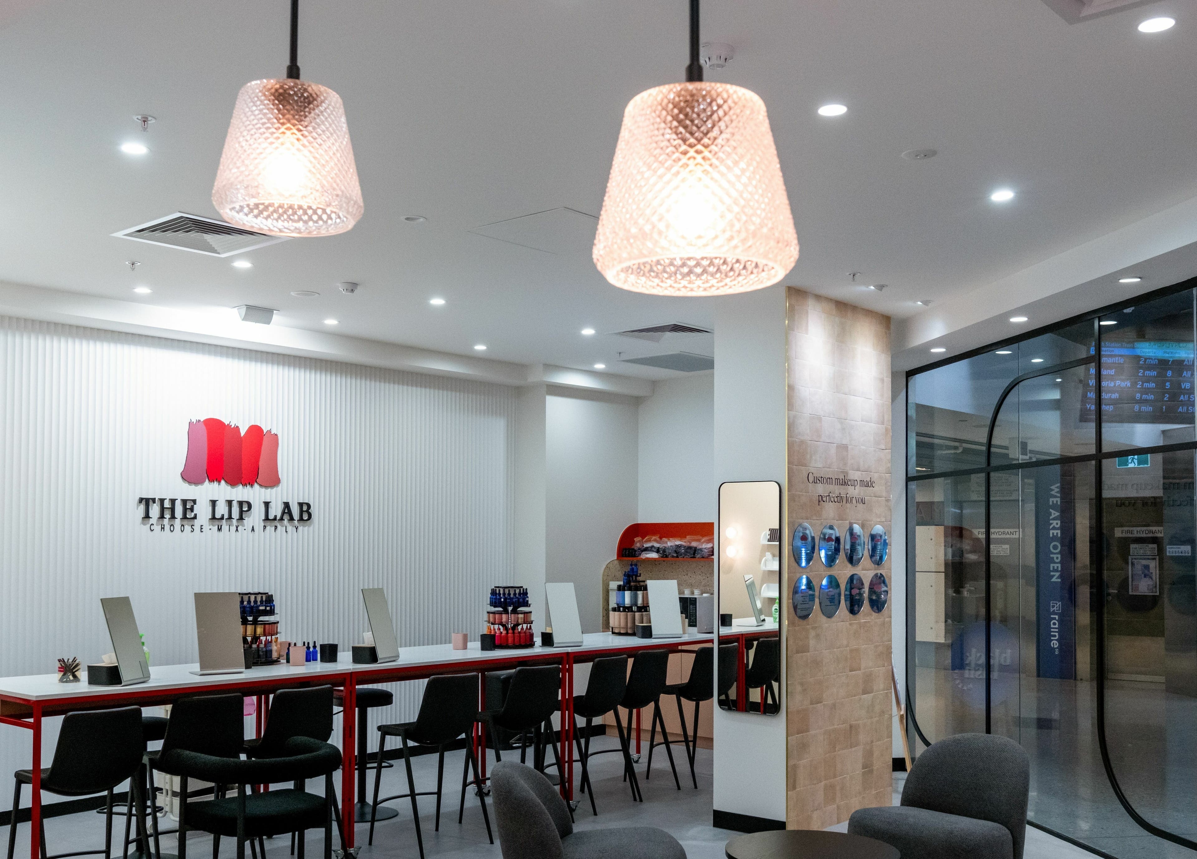 Interior of The Lip Lab in Perth, Western Australia, AU showcasing stylish seating and makeup stations.