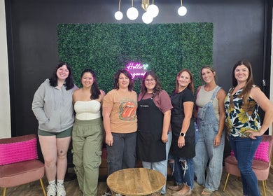 Group of seven smiling women at Beauty Revival, Ashland, Ohio, US, showcasing vibrant community spirit.