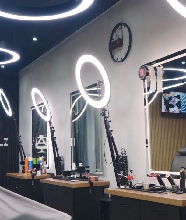 Sleek interior of Initialz Barbers in London, England, GB with modern lighting and barber chairs.