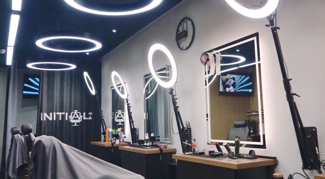 Sleek interior of Initialz Barbers in London, England, GB with modern lighting and barber chairs.