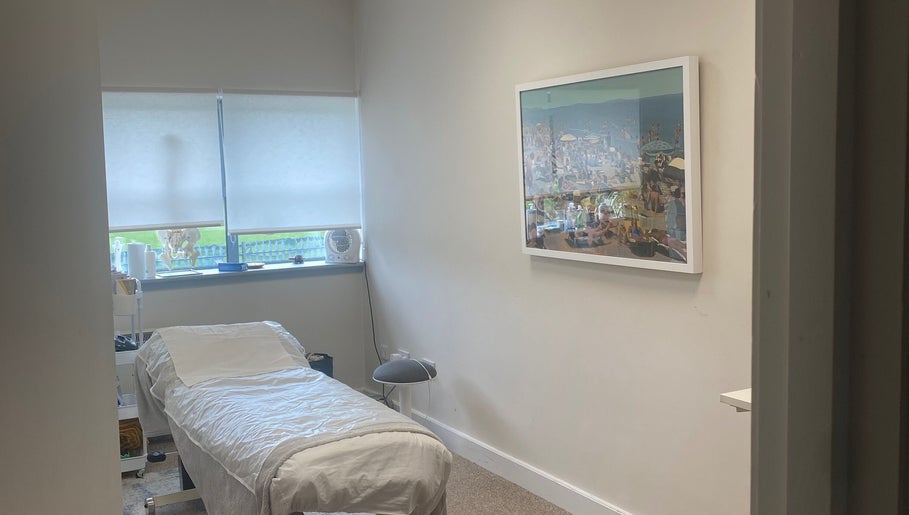 Calm treatment room at JKA Glamour Beauty, Bray, County Wicklow, IE with a massage bed and serene artwork.