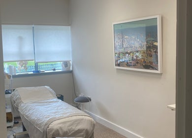 Calm treatment room at JKA Glamour Beauty, Bray, County Wicklow, IE with a massage bed and serene artwork.