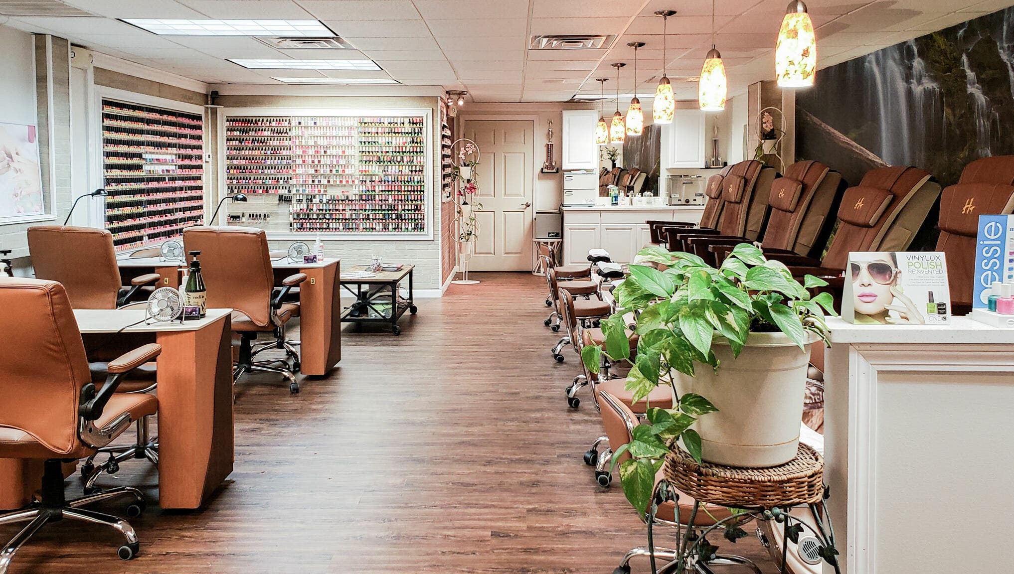 Interior of Quality Nails Spa in Hingham, Massachusetts, US, showcasing stylish nail stations and pedicure chairs.