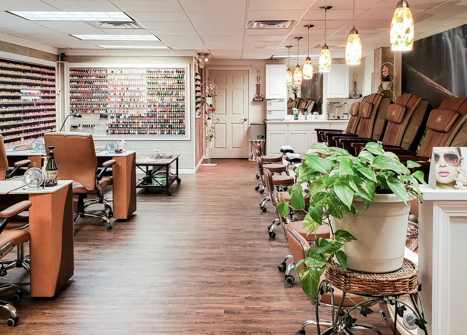 Interior of Quality Nails Spa in Hingham, Massachusetts, US, showcasing stylish nail stations and pedicure chairs.