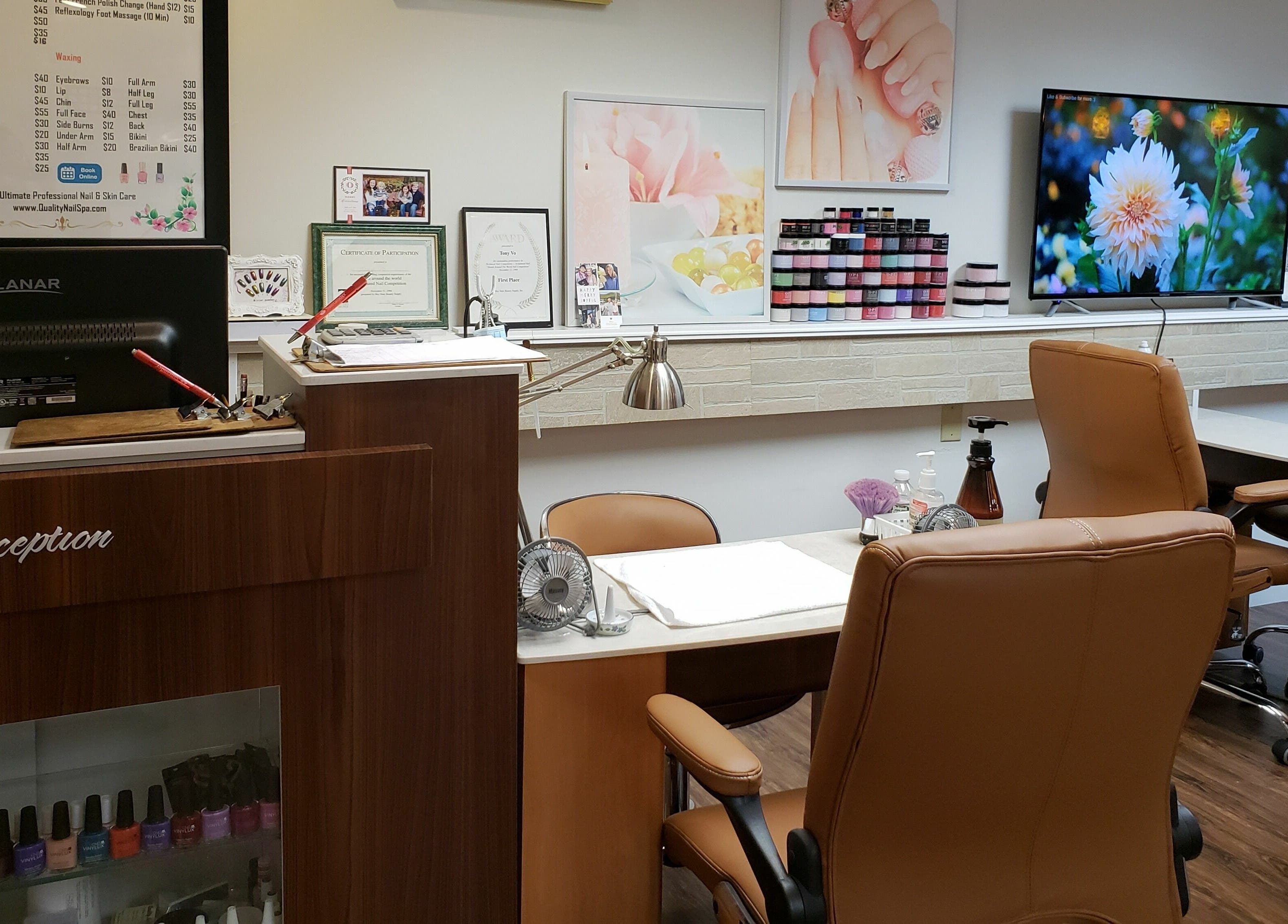 Reception area at Quality Nails Spa in Hingham, Massachusetts featuring cozy seating and vibrant decor.