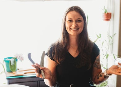 Massage with Liz, LLC therapist holding massage tools in a serene Springfield, Oregon, US setting.