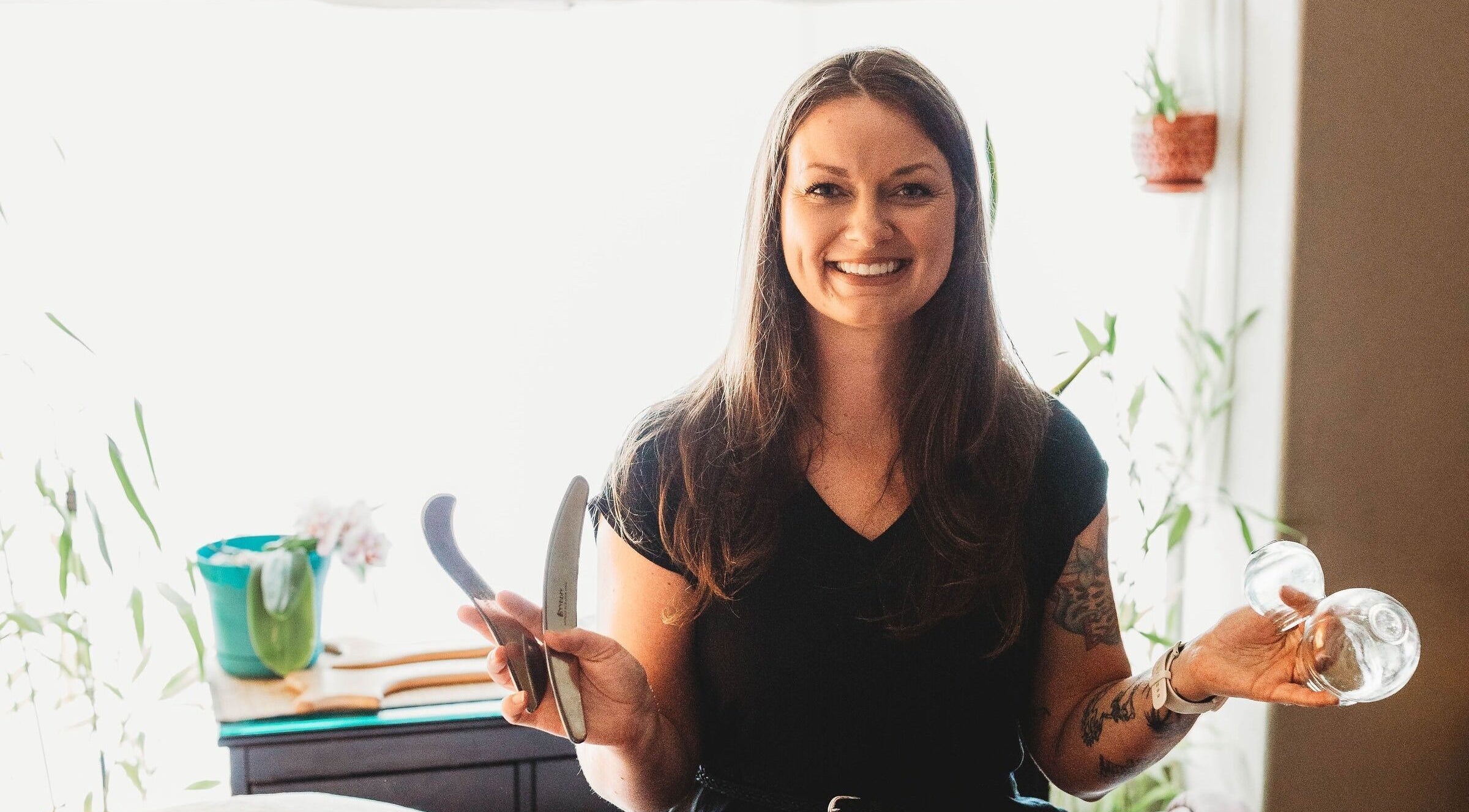 Massage with Liz, LLC therapist holding massage tools in a serene Springfield, Oregon, US setting.