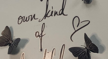 Inspirational wall art with butterflies at Glamazon Salon, Nassau, New Providence, BS, promoting self-love.