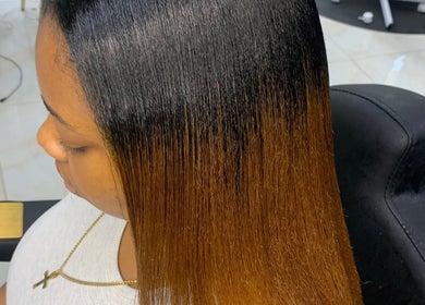Sleek ombre hairstyle at Glamazon Salon, Nassau, New Providence, BS, showcasing glossy, straightened hair.