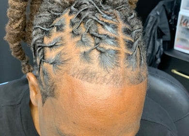 Intricately braided hairstyle at Glamazon Salon, Nassau, New Providence, BS, showcasing expert styling.