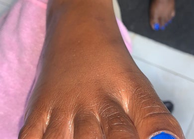 Close-up of a blue nail manicure at Glamazon Salon, Nassau, New Providence, BS.