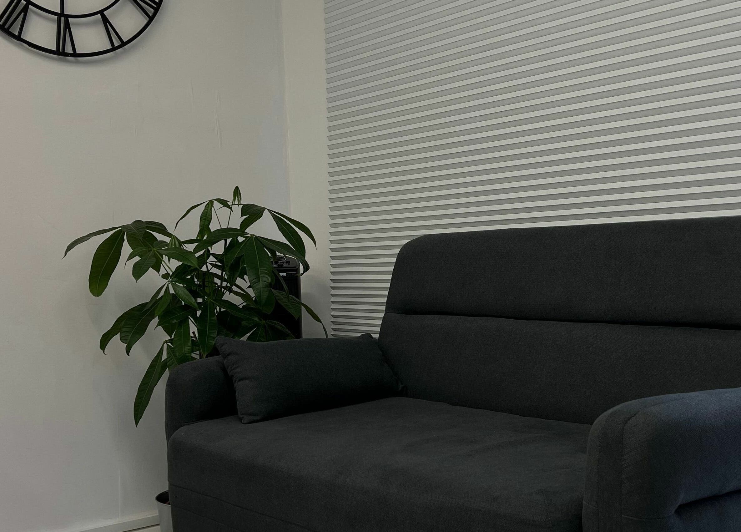 Chic waiting area with sofa and plant at Point G, London, England, GB.