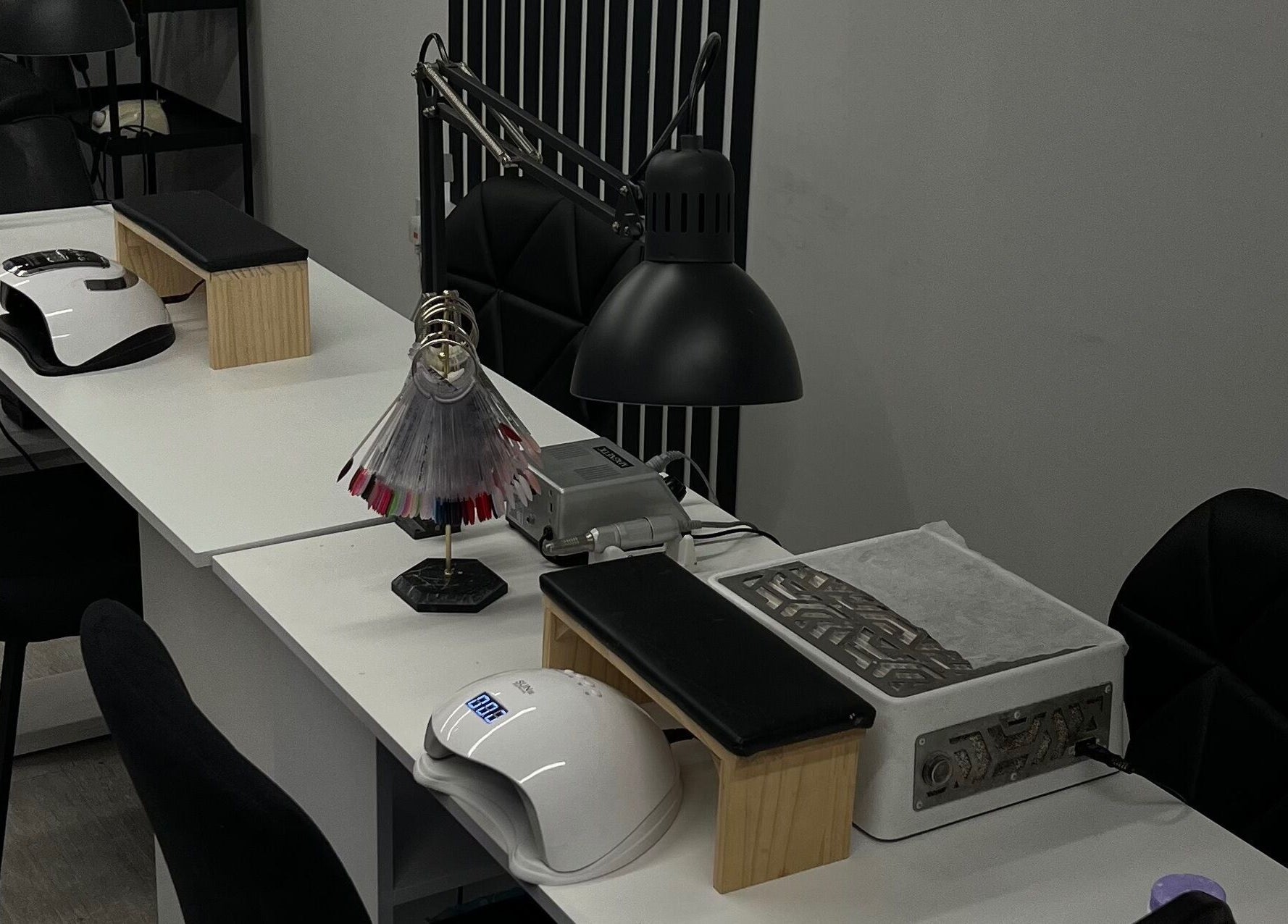 Elegant nail station at Point G, London, England, GB, showcasing modern beauty equipment and seating.