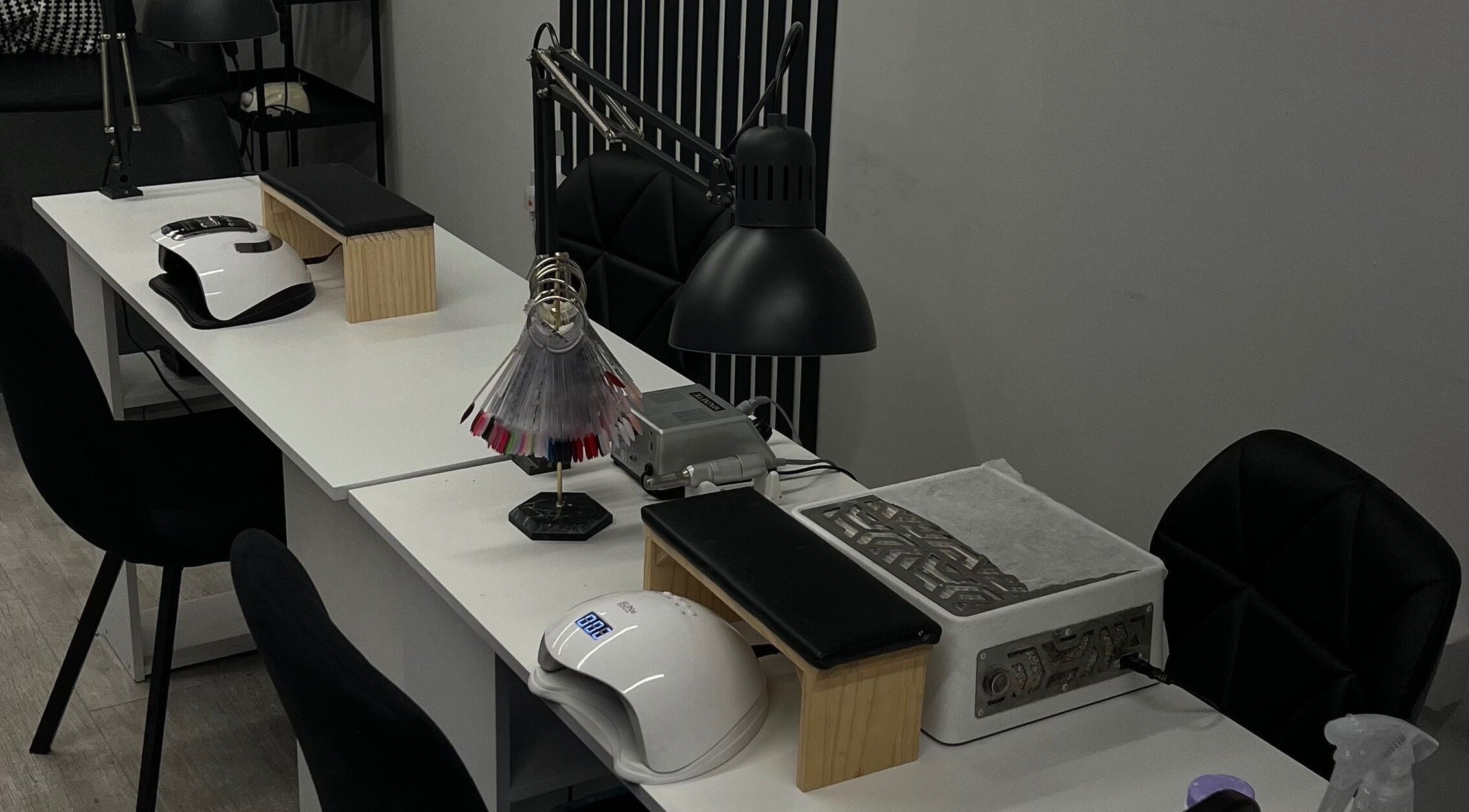 Elegant nail station at Point G, London, England, GB, showcasing modern beauty equipment and seating.