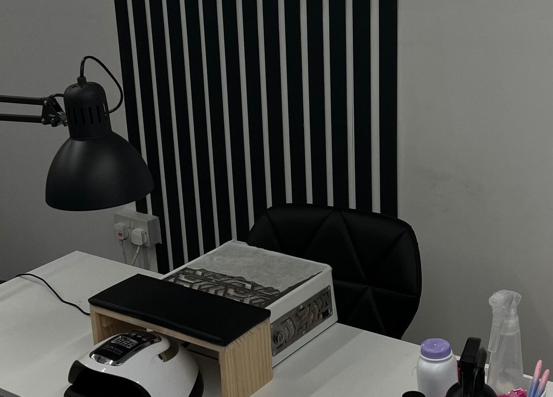 Sleek nail station at Point G, London, England, GB with modern decor and professional lamp.