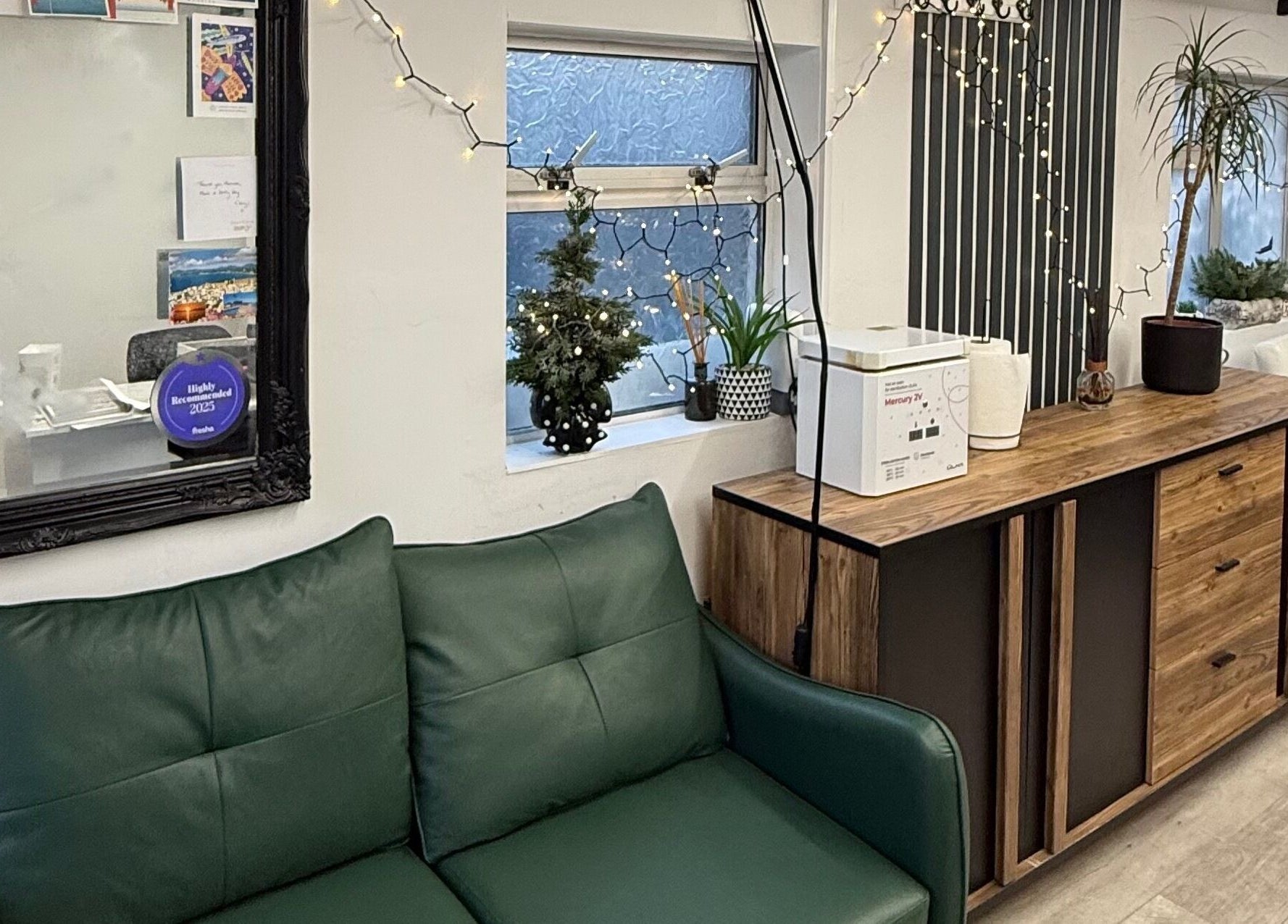 Warm interior of Point G in London, England, GB, featuring green sofa and elegant wooden decor.