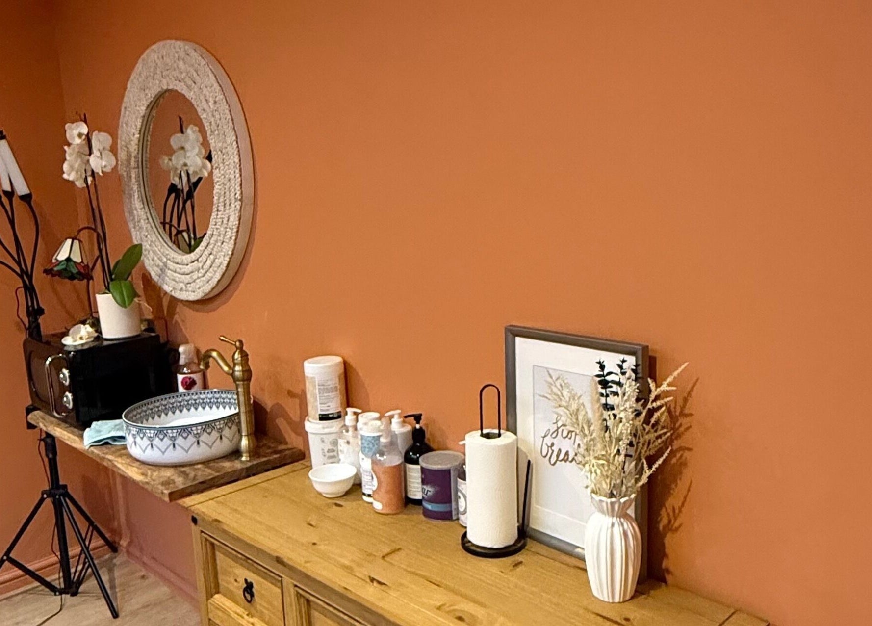 Elegant decor at Point G, London, England, GB with mirror, sink, and beauty products on warm-toned wall.