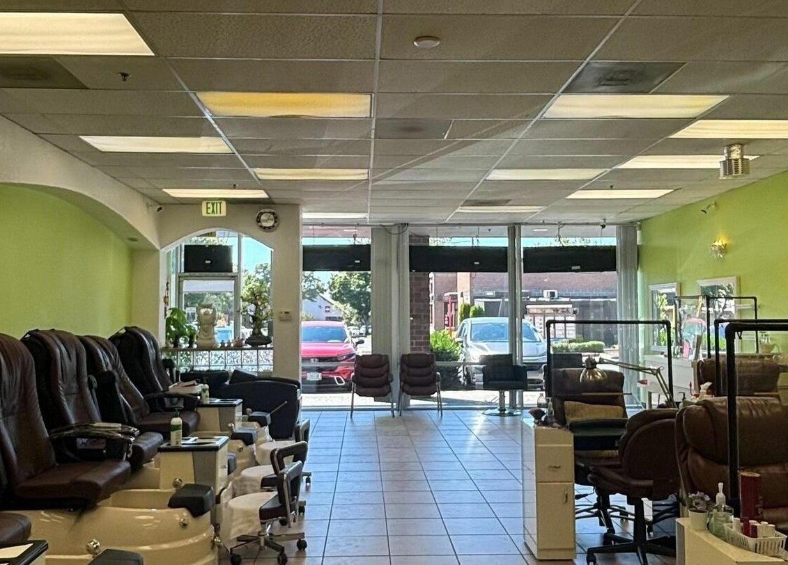 Spacious interior of Great Professional TA Nails in Beaverton, Oregon, US, featuring green walls and comfy chairs.