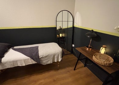 Serene treatment room at Vs Skin, Glasgow, Scotland, GB, featuring a cozy bed and ambient lighting.