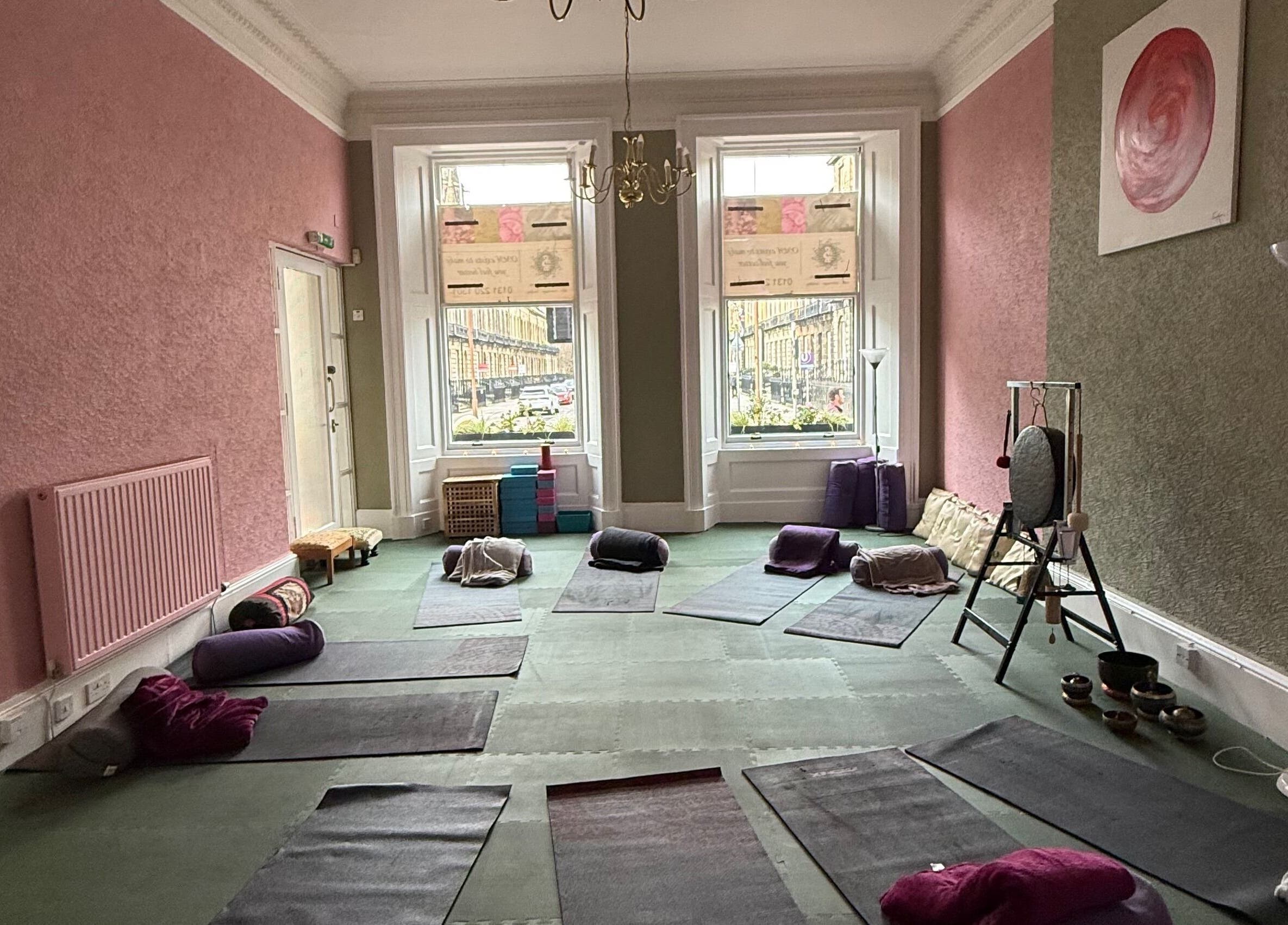 OMH Wellness Studio's serene yoga room in Edinburgh, Scotland, GB, featuring mats and calming decor.
