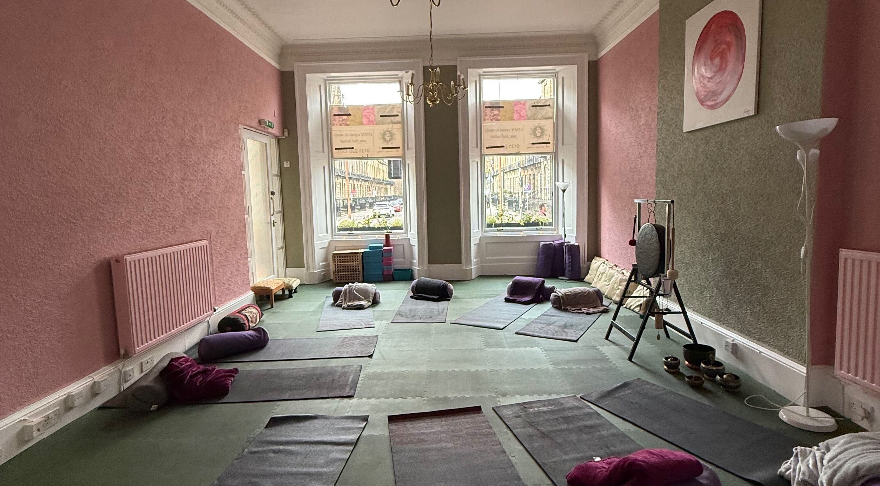 OMH Wellness Studio's serene yoga room in Edinburgh, Scotland, GB, featuring mats and calming decor.