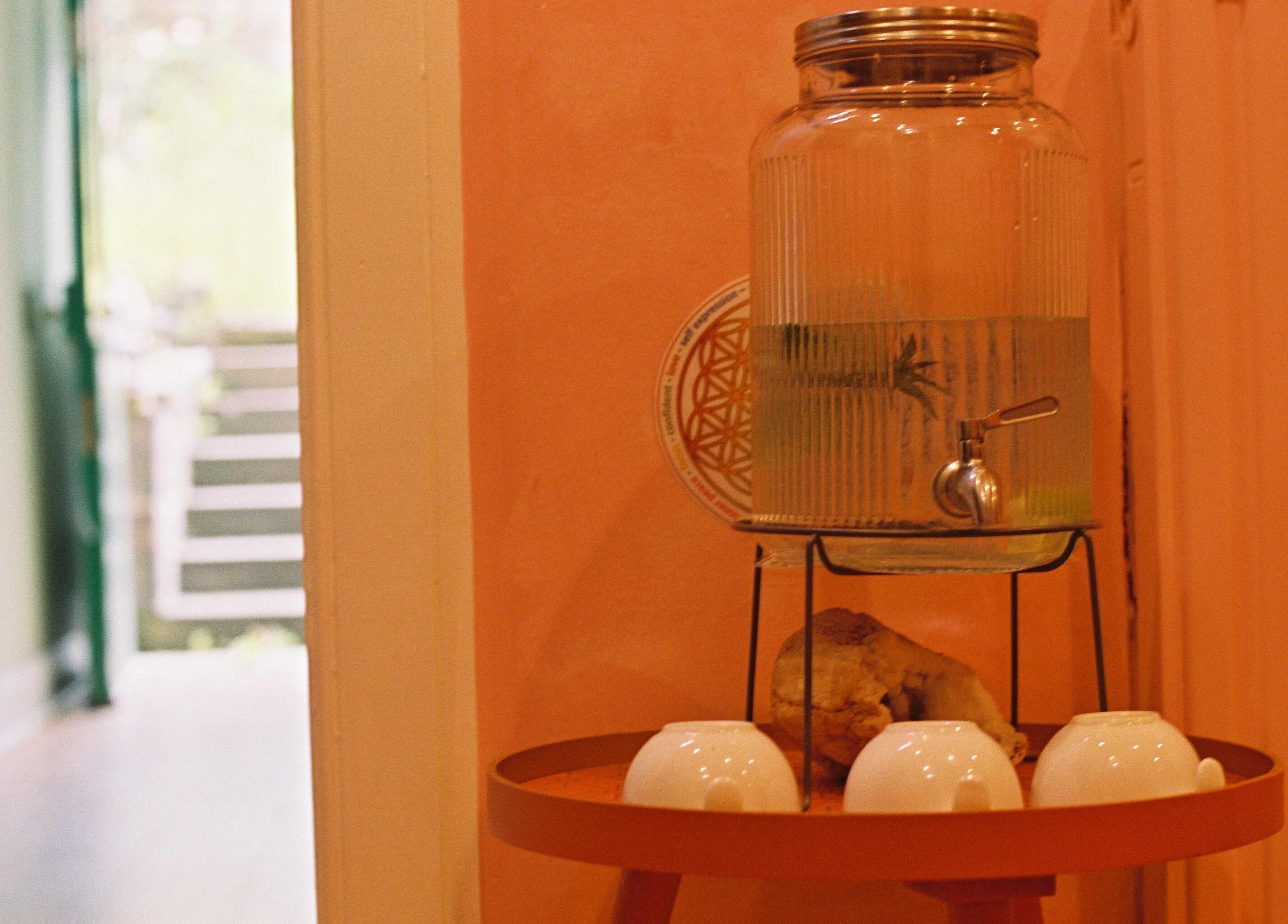 Cozy refreshment corner at OMH Wellness Studio, Edinburgh, Scotland, GB featuring water and cups.
