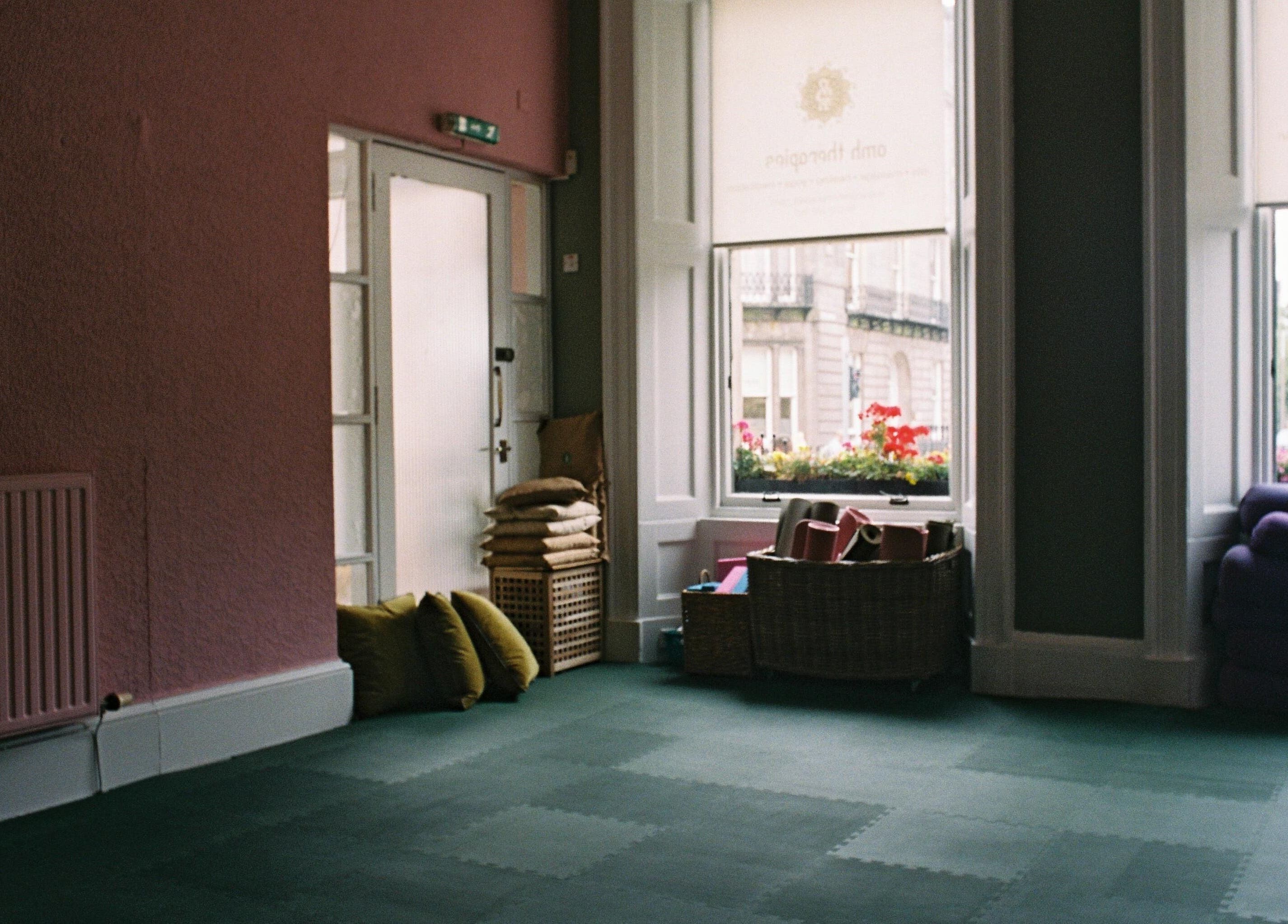 Spacious yoga room with cushions at OMH Wellness Studio, Edinburgh, Scotland, GB.