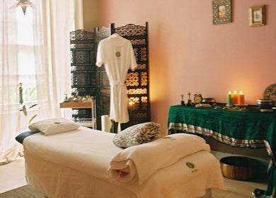 Relaxing therapy room at OMH Therapies Yoga & Meditation Studio Edinburgh, Edinburgh, Scotland, GB, with candles and a massage table.