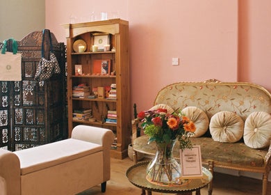 Cozy seating at OMH Therapies Yoga & Meditation Studio Edinburgh, Scotland, GB with pink walls and elegant decor.