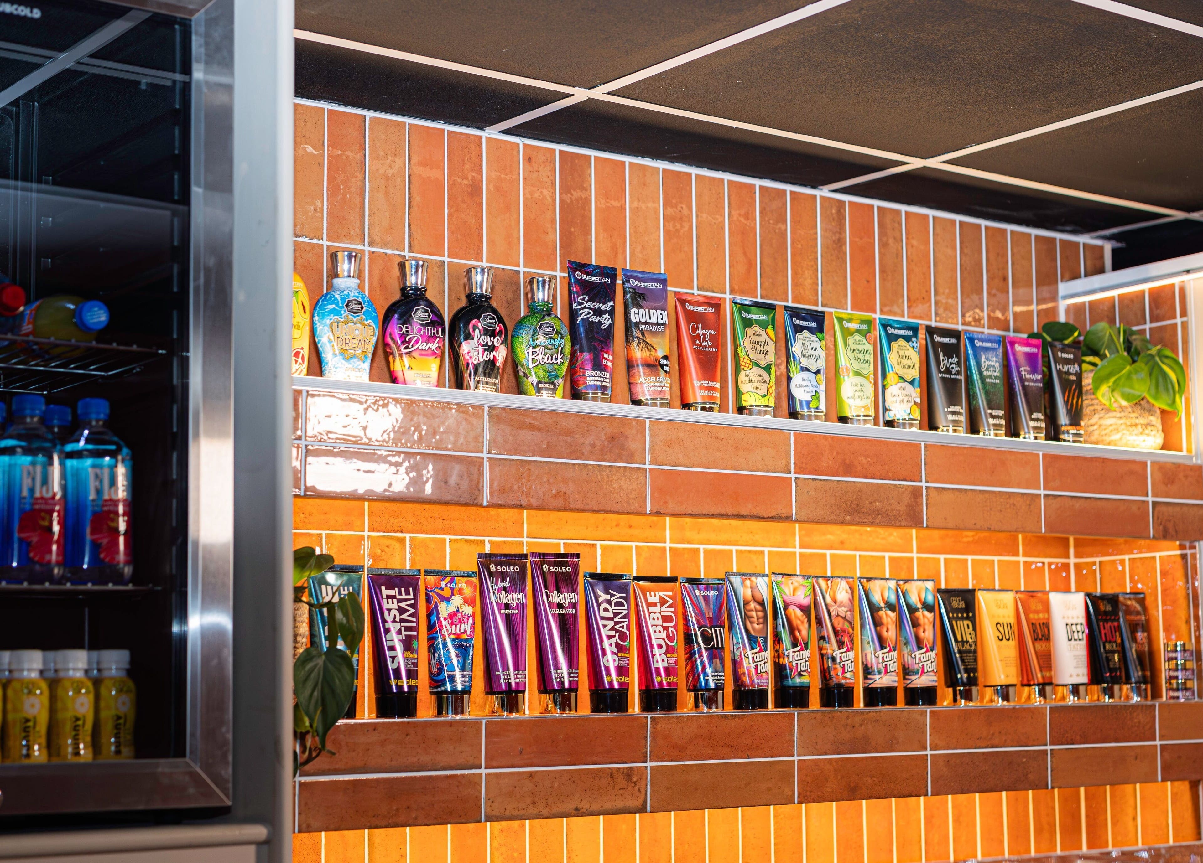 Shelf with beauty products and drinks at Glow Club, Skegness, GB offering a vibrant selection.