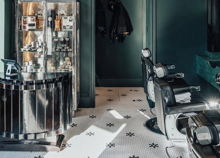 Sophisticated interior of Anvil Barbers in London, England, GB showcasing chic chairs and grooming products.
