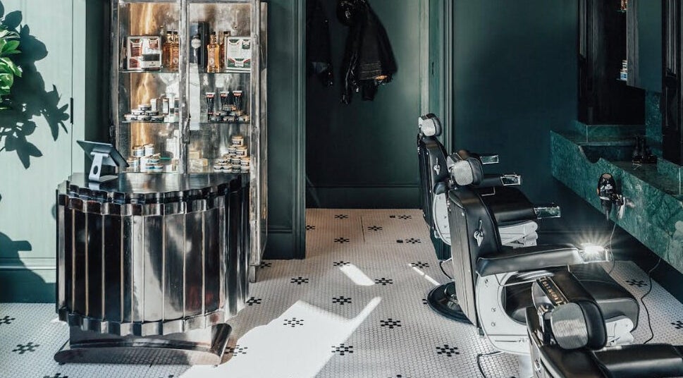 Sophisticated interior of Anvil Barbers in London, England, GB showcasing chic chairs and grooming products.