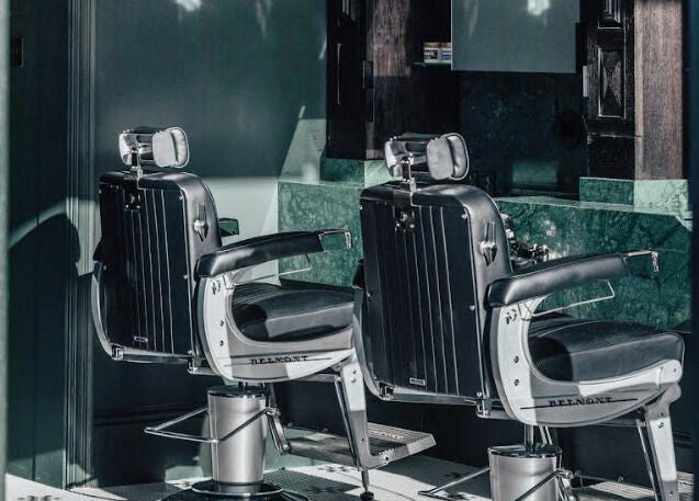 Stylish barber chairs at Anvil Barbers, London, England, GB showcasing modern grooming elegance.
